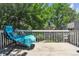 Relaxing balcony area with a hanging chair, shaded by green trees at 7183 S Poplar St, Centennial, CO 80112