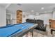 Finished basement featuring a billiards table, wet bar, and home theater setup with comfortable seating at 7183 S Poplar St, Centennial, CO 80112