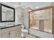 Clean bathroom features a vanity sink, toilet, and tiled shower with glass door at 7183 S Poplar St, Centennial, CO 80112