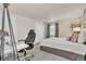 A bedroom featuring an office desk, a chair, a bed, and a large window at 7183 S Poplar St, Centennial, CO 80112