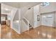 Spacious foyer with hardwood floors, staircase, and ample natural light, creates an inviting entrance to the home at 7183 S Poplar St, Centennial, CO 80112