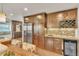 Gourmet kitchen features custom cabinetry, stainless steel appliances, and a wine rack, ideal for culinary enthusiasts at 7183 S Poplar St, Centennial, CO 80112