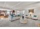 Open living space with hardwood floors seamlessly connecting the kitchen, dining area, and foyer for easy entertaining at 7183 S Poplar St, Centennial, CO 80112