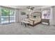 Spacious main bedroom with a ceiling fan, bench, and sliding door to the outdoor patio at 7183 S Poplar St, Centennial, CO 80112
