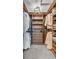 Walk-in closet with wooden shelves, drawers, and racks for organized clothing storage at 7183 S Poplar St, Centennial, CO 80112