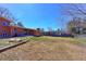 Expansive backyard offers a patio and brick home with mature trees and ample space for outdoor enjoyment and recreation at 383 S 21St Ave, Brighton, CO 80601