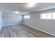 Finished basement with stylish wood-look flooring, multiple windows, and a clean, bright space ideal for recreation at 383 S 21St Ave, Brighton, CO 80601