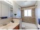 Well-maintained bathroom with tiled shower and bath, a classic vanity, and decorative accents that enhance the space at 383 S 21St Ave, Brighton, CO 80601