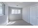 Cozy bedroom featuring neutral carpet, ample natural light from the triple window, and a closet for convenient storage at 383 S 21St Ave, Brighton, CO 80601