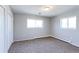 Neutral bedroom with closet, two windows, neutral carpet, and a heater at 383 S 21St Ave, Brighton, CO 80601