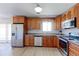 Stylish kitchen features stainless steel appliances, wooden cabinets, and light hard wood flooring at 383 S 21St Ave, Brighton, CO 80601