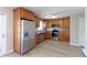 Well-lit kitchen features stainless steel appliances, wooden cabinets, and light hard wood flooring at 383 S 21St Ave, Brighton, CO 80601