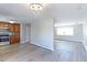 Open kitchen features stainless steel appliances, and a chandelier-style light fixture at 383 S 21St Ave, Brighton, CO 80601