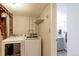 Convenient laundry room with modern washer and dryer, easy access to plumbing, and a nearby bathroom at 383 S 21St Ave, Brighton, CO 80601