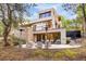 Modern back patio with seating area, stone accents, and beautiful views of surrounding trees at 1250 Dolan Dr, Monument, CO 80132