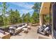 Back patio with stylish furniture and views of the surrounding forest at 1250 Dolan Dr, Monument, CO 80132