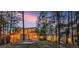 Home at twilight, showcasing a beautifully landscaped backyard and exterior lighting at 1250 Dolan Dr, Monument, CO 80132