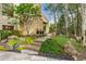 This backyard features a stone patio with lush landscaping and wooded views at 1250 Dolan Dr, Monument, CO 80132