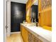 Stylish powder room with modern vanity, vessel sink, and a unique black accent wall at 1250 Dolan Dr, Monument, CO 80132