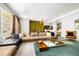 Spacious living room with modern decor, large sectional couch, and stylish coffee table on soft blue area rug at 1250 Dolan Dr, Monument, CO 80132