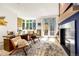Bright home office with fireplace, custom built-ins, and views of a wooded area at 1250 Dolan Dr, Monument, CO 80132