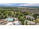 Expansive aerial view showcases community pool, tennis courts, green spaces, and mountain views at 8626 Gold Peak Dr # B, Highlands Ranch, CO 80130