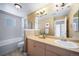 Well-lit bathroom with a bath-shower combination, large vanity, and ample storage space at 8626 Gold Peak Dr # B, Highlands Ranch, CO 80130