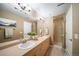 Bathroom with dual sinks, neutral walls, and walk-in shower at 8626 Gold Peak Dr # B, Highlands Ranch, CO 80130