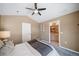 Bedroom with ensuite bath, ceiling fan and neutral decor at 8626 Gold Peak Dr # B, Highlands Ranch, CO 80130