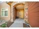 Charming front entrance with a stone archway and a welcoming yellow door at 8626 Gold Peak Dr # B, Highlands Ranch, CO 80130
