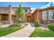 Inviting two-story home with a well-manicured front yard and stone accents at 8626 Gold Peak Dr # B, Highlands Ranch, CO 80130