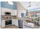 Modern kitchen featuring stainless steel appliances, granite countertops, and a mosaic tile backsplash at 8626 Gold Peak Dr # B, Highlands Ranch, CO 80130