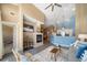 Open living area with a modern fireplace and seamlessly connected to the kitchen at 8626 Gold Peak Dr # B, Highlands Ranch, CO 80130