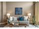 Modern living room with a comfortable couch, stylish decor, and plenty of natural light at 8626 Gold Peak Dr # B, Highlands Ranch, CO 80130