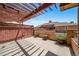 View of private patio featuring pergola, potted plants, and fenced barrier at 8626 Gold Peak Dr # B, Highlands Ranch, CO 80130