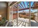 View of private patio, with pergola, outside of the home's sliding glass doors at 8626 Gold Peak Dr # B, Highlands Ranch, CO 80130