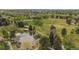 Scenic aerial view of a pond with a fountain nestled within lush green surroundings and walking trails at 8626 Gold Peak Dr # B, Highlands Ranch, CO 80130