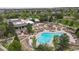 Overhead view of community pool with clubhouse surrounded by mature landscaping at 8626 Gold Peak Dr # B, Highlands Ranch, CO 80130