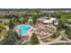 Aerial view of a luxurious pool area with ample seating and a beautifully designed clubhouse at 8626 Gold Peak Dr # B, Highlands Ranch, CO 80130