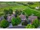 An aerial shot of neighborhood homes showcases lush greenery and a soccer field in the distance at 12350 Turquoise Terrace St, Castle Pines, CO 80108