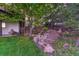 Backyard featuring stone steps leading to a higher tier, lush greenery, and a rock garden at 12350 Turquoise Terrace St, Castle Pines, CO 80108