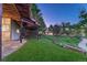 Backyard with a green lawn, a ground-level stone patio, and a view of neighborhood hillsides at 12350 Turquoise Terrace St, Castle Pines, CO 80108