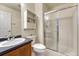 Bathroom featuring a shower with a glass door, a sink and a toilet at 12350 Turquoise Terrace St, Castle Pines, CO 80108