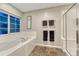 Bright bathroom featuring a soaking tub, shower and tile flooring at 12350 Turquoise Terrace St, Castle Pines, CO 80108