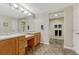 Bathroom featuring double vanity, tile flooring, and tub with shower, providing comfort and practicality at 12350 Turquoise Terrace St, Castle Pines, CO 80108