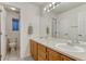 Bathroom featuring double sinks, a large vanity, and a separate toilet room for added privacy at 12350 Turquoise Terrace St, Castle Pines, CO 80108