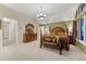 Spacious bedroom featuring a decorative chandelier, wooden furniture and a bench at 12350 Turquoise Terrace St, Castle Pines, CO 80108