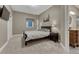 Bedroom with neutral paint, carpet, a window, and a doorway to an attached bathroom at 12350 Turquoise Terrace St, Castle Pines, CO 80108