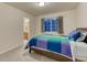 Bedroom with a comfortable bed and colorful bedding and view of a bathroom at 12350 Turquoise Terrace St, Castle Pines, CO 80108