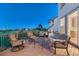 The wooden deck is furnished with a cozy outdoor seating area, a grill and overlooks a grassy field at 12350 Turquoise Terrace St, Castle Pines, CO 80108